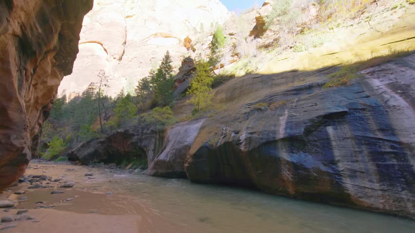Experience the unparalleled adventure of hiking The Narrows, the narrowest section of Zion Canyon in Zion National Park, Utah. This footage captures the stunning scenery of the Virgin River flowing be