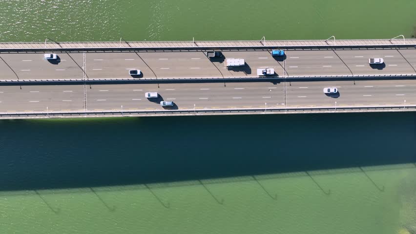 Static top down birds eye shot of cars driving across a bridge in Sydney, Australia