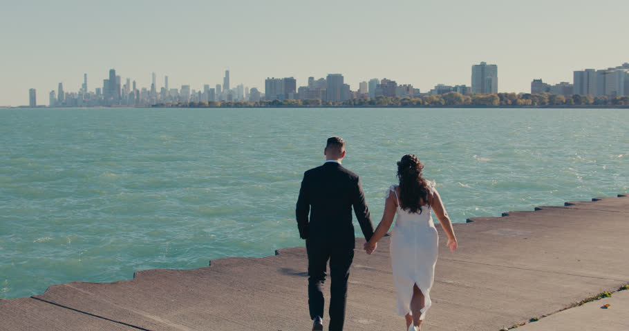 Romantic wedding couple kissing near chicago skyline