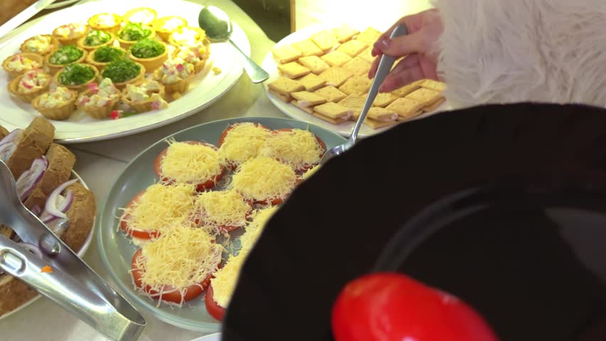 tartlets with salad Restaurant guests select food from a buffet.