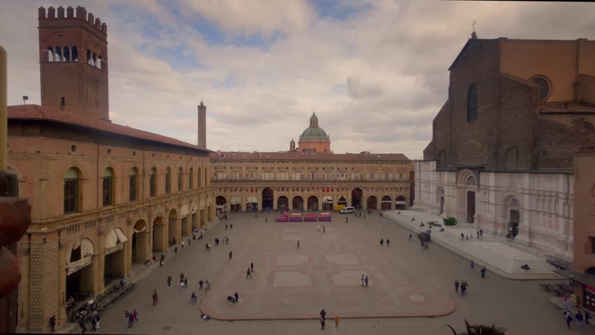 Timelapse view of Piazza Maggiore in Bologna, Italy, showcasing historic architecture, lively urban atmosphere, and dynamic city life. The iconic square features medieval and Renaissance buildings, bustling crowds, and changing light from day to night. Ideal for themes of travel, tourism, European culture, historic cities, and urban time-lapse sequences.