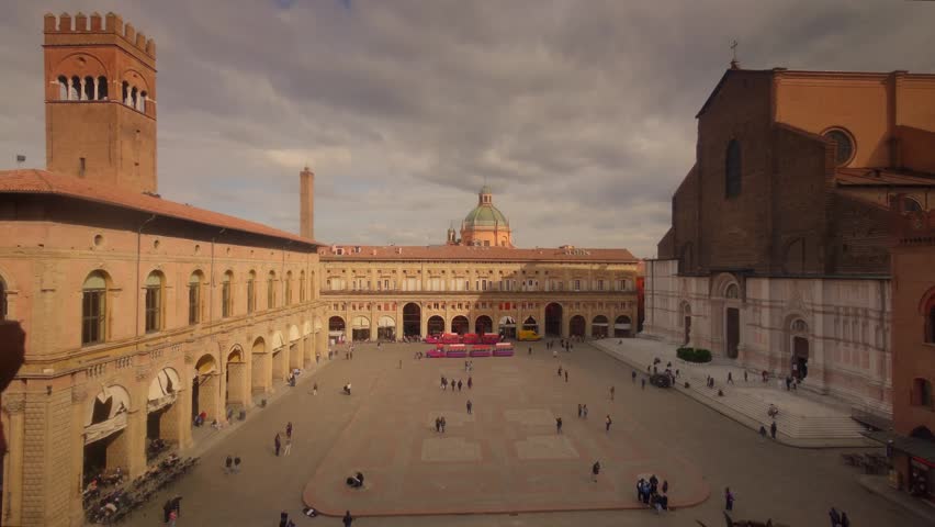 Timelapse view of Piazza Maggiore in Bologna, Italy, showcasing historic architecture, lively urban atmosphere, and dynamic city life. The iconic square features medieval and Renaissance buildings, bustling crowds, and changing light from day to night. Ideal for themes of travel, tourism, European culture, historic cities, and urban time-lapse sequences.