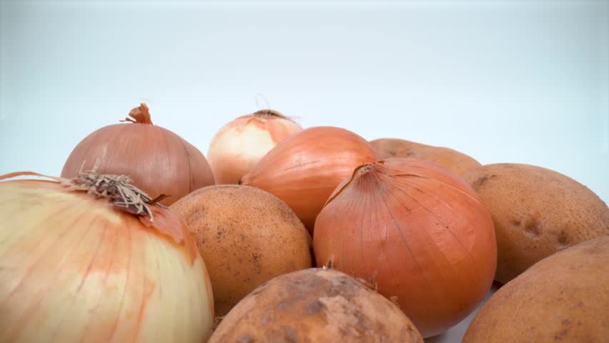 Close up of potatoes and onions on white background isolated