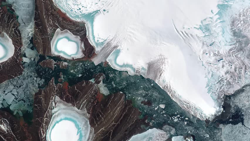 Panoramic top view of icy land and water covered with pieces of ice. Camera is zooming in, rotating clockwise. Animation based on image by NASA