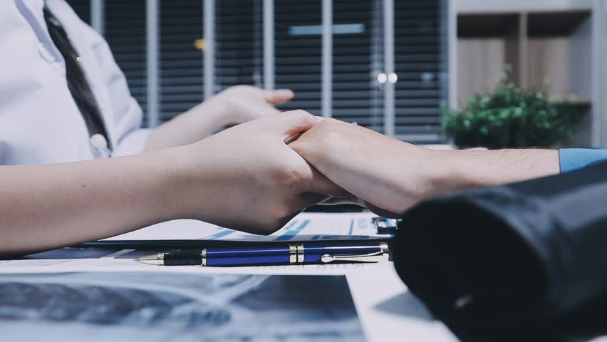 Compassionate doctors offer support and empathy by holding hands in a gesture of solidarity, showing care and understanding in healthcare settings