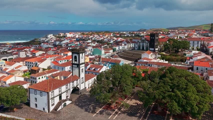 Aerial view of Ribeira Grande city on Sao Miguel Island, Azores, Portugal. Traditional white buildings along the Atlantic coast with lush volcanic hills.