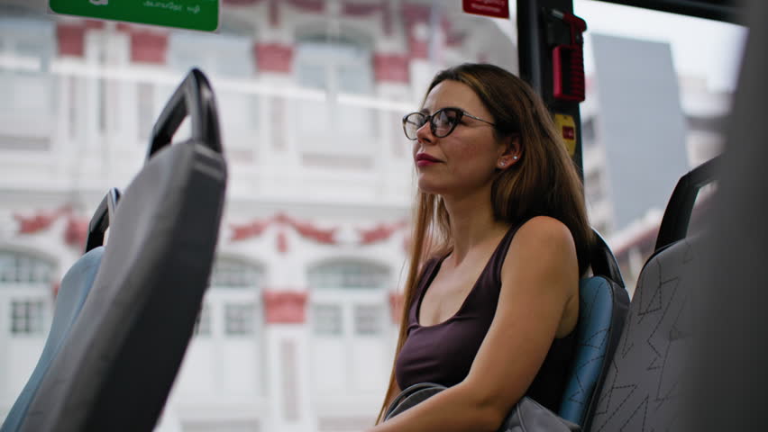 Tourist woman commuting by city bus, authentic public transport experience and travel adventure in vibrant metropolis