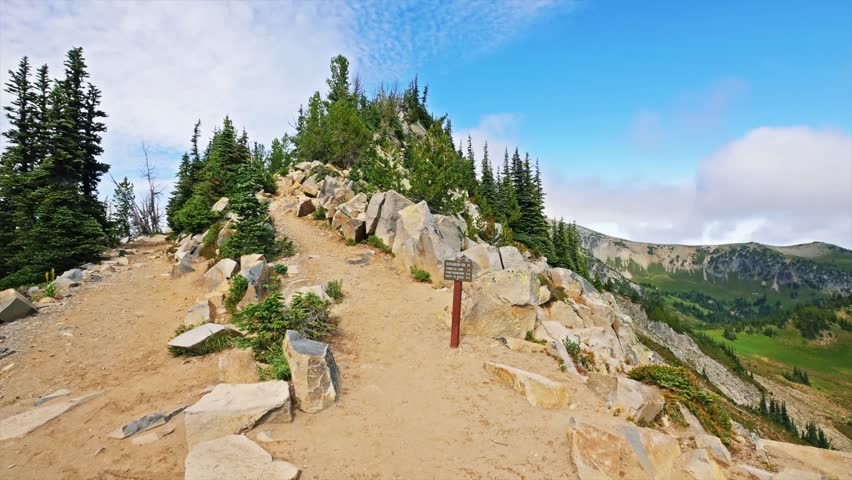 A high-alpine trail leading up a rocky ridgeline towards the historic Mount Fremont fire lookout tower, offering panoramic views of Mount Rainier and surrounding peaks. The trail is a popular, moderat
