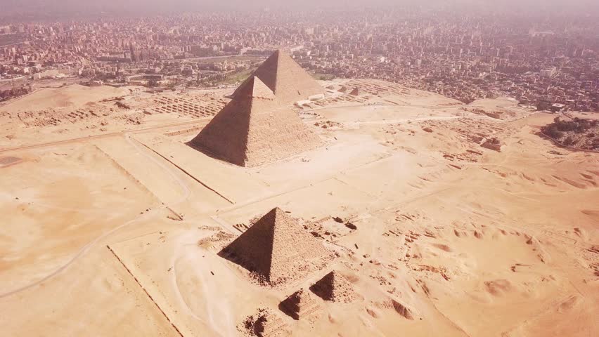 Aerial view of ancient Giza in Egypt showcasing historic pyramids and archaeological landscape. Iconic African civilization landmark highlighting heritage, travel destination, desert environment, and timeless architecture under clear sky.