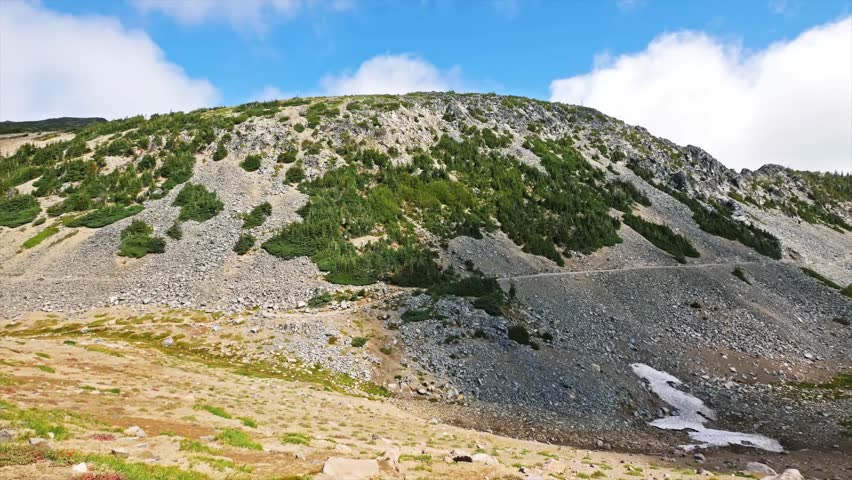 Footage of the breathtaking landscape and rocky terrain along the moderate Mount Fremont Lookout Trail, leading to a historic 1934 fire lookout at 7,181 feet elevation in the Sunrise area of Mount Rai
