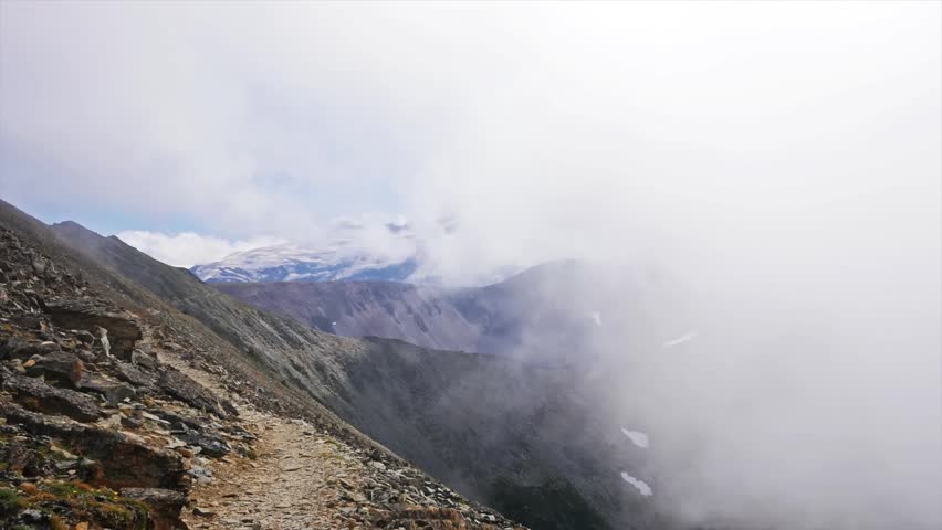 footage captures a hiker on the rocky, exposed trail leading to the historic Mount Fremont Fire Lookout, one of the highest points accessible by trail in Mount Rainier National Park. The trail offers
