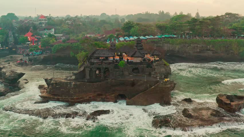 Beautiful beach with old rock formations in Tanah Lot, Bali, Indonesia
