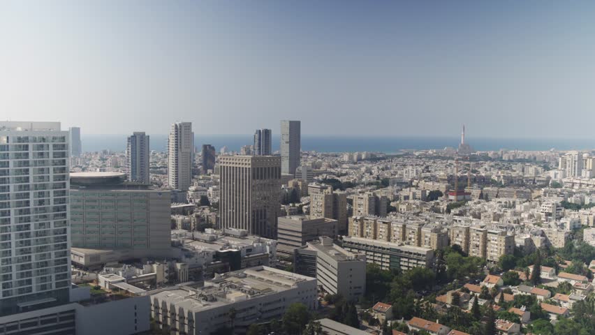 Panoramic aerial view of Tel Aviv city skyline with mediterranean sea on horizon during sunny day in Israel