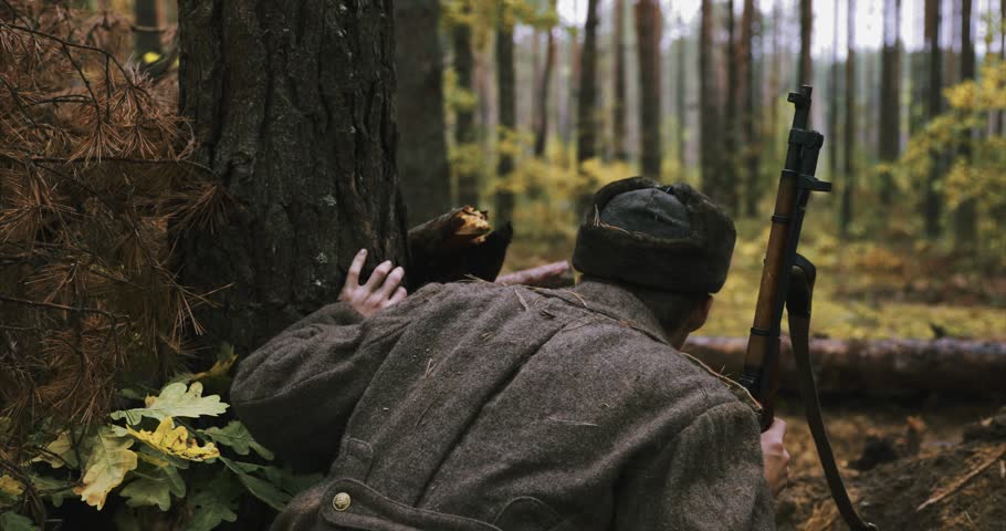 Hidden Re-enactor Dressed Like Russian Soviet Infantry Red Army Soldier In World War II Sitting Trench Entrenchment Ambush Autumn Forest. Historical Re-enactment. at