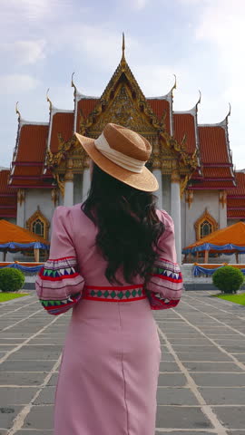 Tourists visiting at Wat Benchamabophit or the Marble Temple in Bangkok, Thailand. Vertical