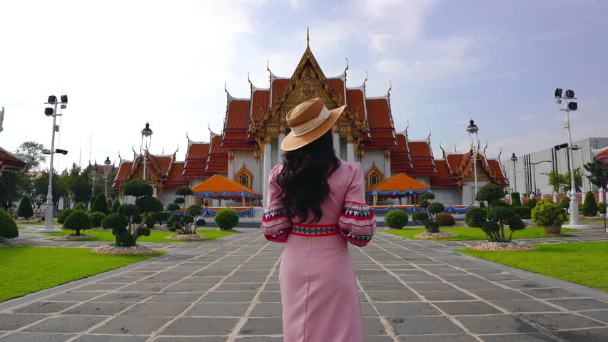 Tourists visiting at Wat Benchamabophit or the Marble Temple in Bangkok, Thailand.