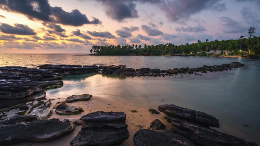 Tropical beach with scenery palm tree and colorful sunset above the ocean 4K