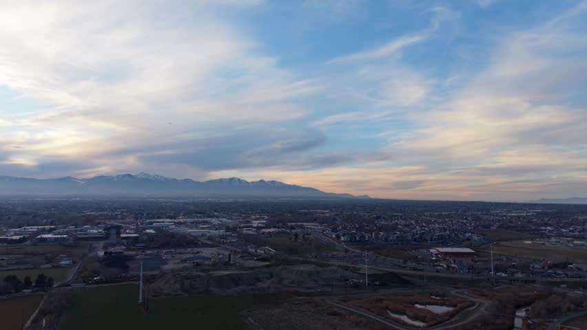 Aerial view of sunset sky over city and mountains in Midvale Utah