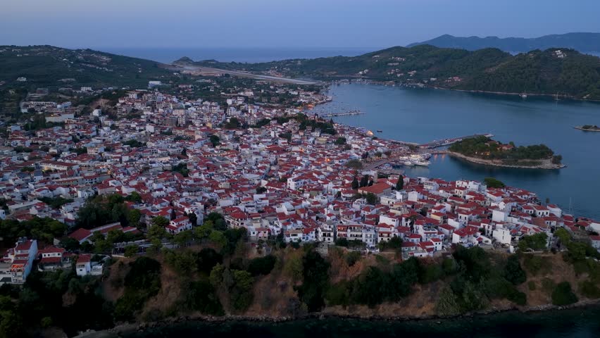 Panoramic summer dusk aerial view of the illuminated town of Skiathos island, Sporades, Greece