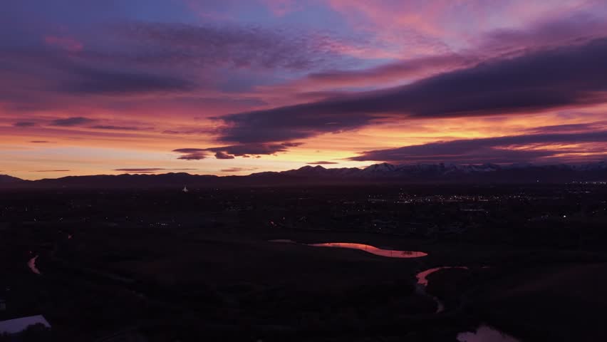 Dramatic purple sunset over mountains and city in Midvale, Utah, USA