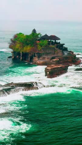 Beautiful beach with old rock formations in Tanah Lot, Bali, Indonesia