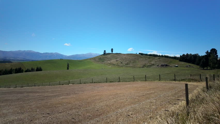 Rolling Green Hills Under Blue Sky