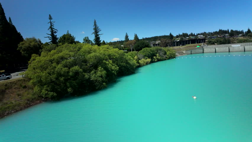 Turquoise Lakeside With Trees And Shore