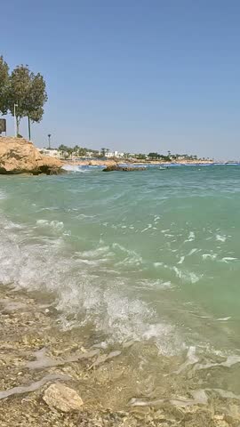 Serene Coastal Views: A Lush Shoreline Merging Blue Skies with Turquoise Waters Capturing the Essence of Tranquility in Nature