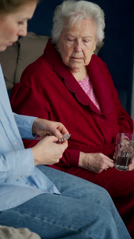 Daughter taking care of ill old mother.