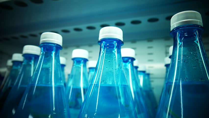 Many blue plastic bottles of potable water on a retail display