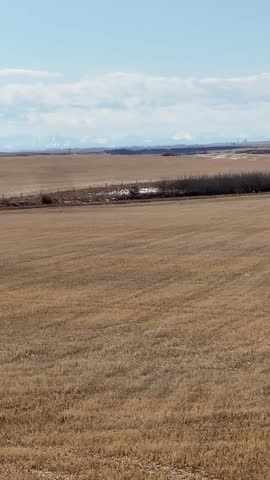 Rural Alberta scenic landscape featuring open prairie terrain with wide horizon natural environment and peaceful countryside view