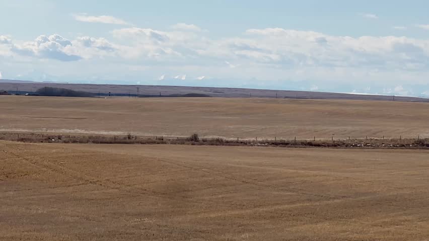 Rural Alberta scenic landscape featuring open prairie terrain with wide horizon natural environment and peaceful countryside view