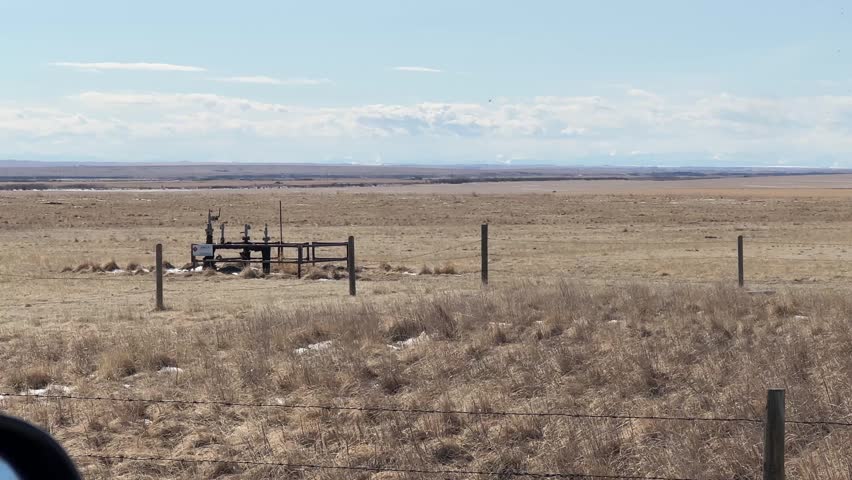 Expansive Alberta prairie landscape with open farmland and vast sky highlighting rural countryside and natural Canadian environment