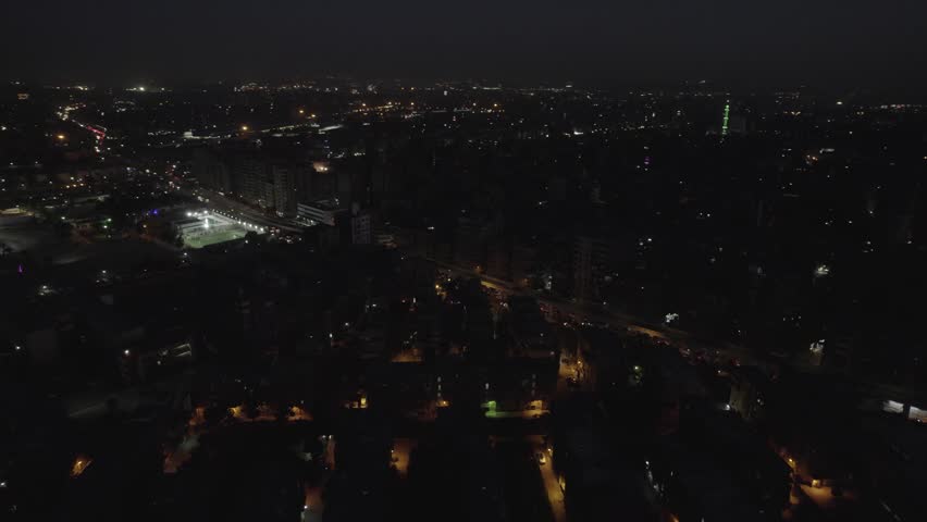 Aerial drone shot of Cairo city at night, Egypt with illuminated skyline, city lights and urban buildings. Night cityscape with traffic and modern urban environment.