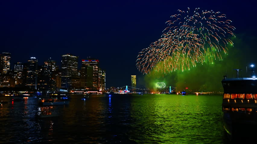 Night celebration in beautiful New York, USA. Fireworks splash in the sky over the East River.