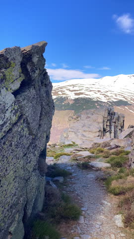 Panoramic view of the snow capped peaks of the Sierra Nevada Mountains revealing dramatic alpine landscapes and winter light in Spain