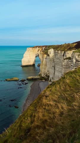 Picturesque coastal limestone cliffs and the English Channel town of Etretat, Normandy, France. High quality 4k footage