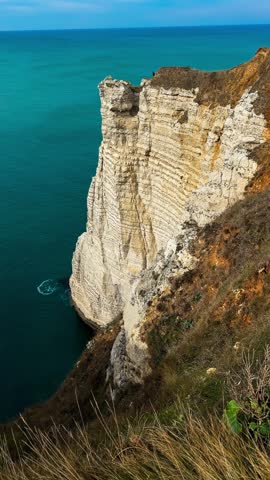 Picturesque coastal limestone cliffs and the English Channel town of Etretat, Normandy, France. High quality 4k footage