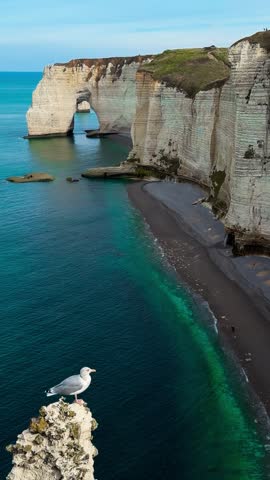 Picturesque coastal limestone cliffs and the English Channel town of Etretat, Normandy, France. High quality 4k footage