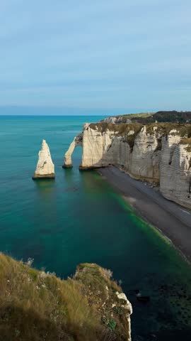 Picturesque coastal limestone cliffs and the English Channel town of Etretat, Normandy, France. High quality 4k footage