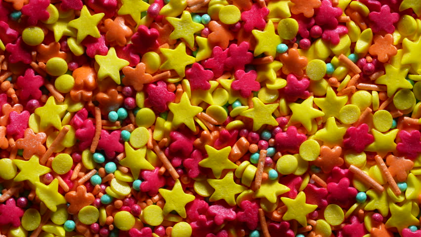 Bright mix of colorful sugar sprinkles in various shapes and sizes top view vibrant background ideal for baking decoration dessert design party and food branding concepts, close up, rotates