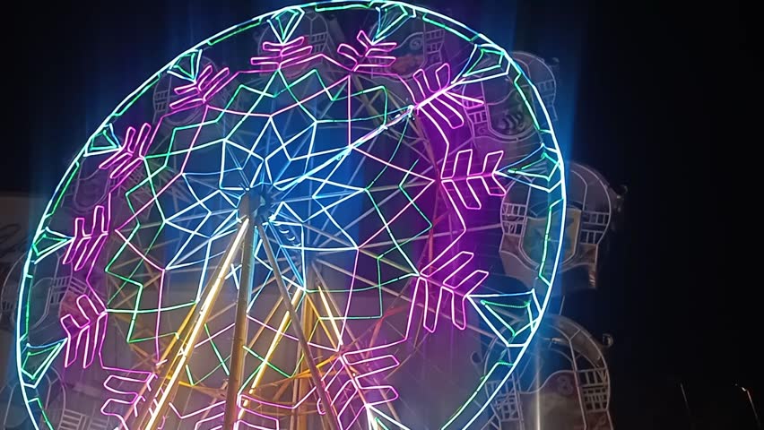 Colorful Carousel Merry-Go-Round Spinning at Night in Amusement Park