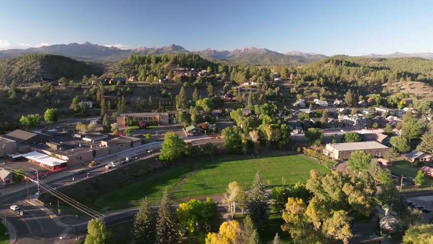 Aerial view of mountain beauty in Pagosa Springs, Colorado fall landscapes capturing autumn colors and natural scenery of San Juan Mountains at golden hour sunset - 4K Drone
