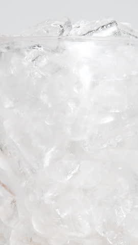  4K Vertical video Refreshing iced matcha green tea drink with crystal clear ice cubes and vibrant green color Close-up beverage, Concept representing freshness summer and healthy lifestyle for commercial use.