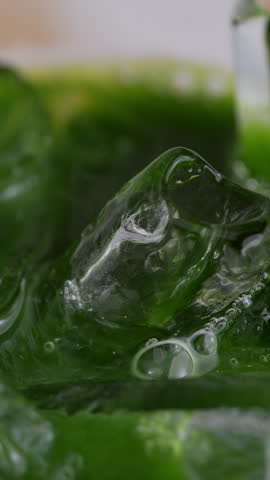 4K Vertical video Abstract green tea or matcha liquid mixing with milk creating smooth swirling patterns Organic fluid texture with vibrant green tones, ideal for beverage concept background and modern design use.