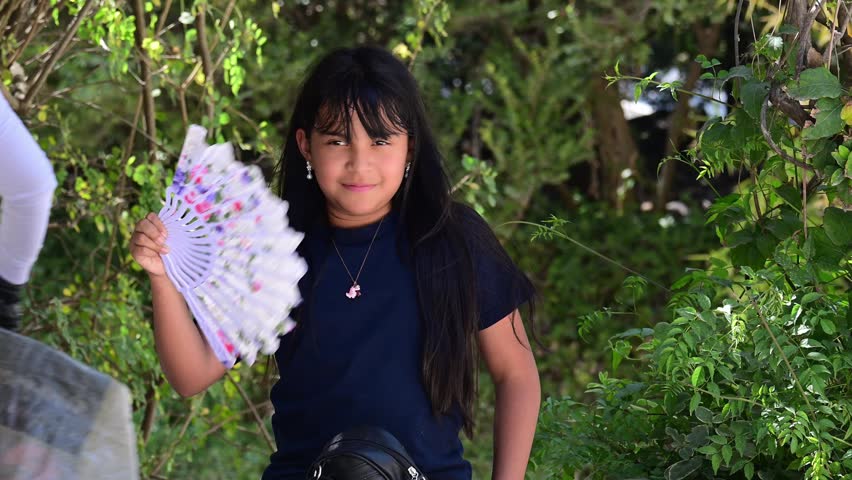 LATINA GIRL FANNING HERSELF WITH A WHITE FAN