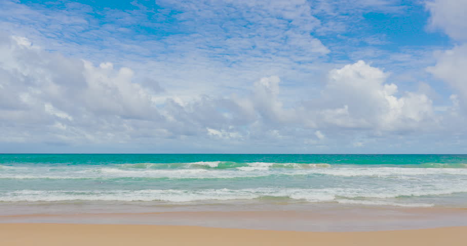Phuket Thailand 2026 Version. Tropical white sand beach with palms, clear blue sea and white clouds on the horizon loop. Summer sea sand sun