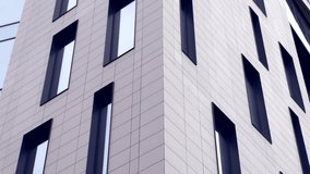 Low angle view of modern glass facade building with rhythmic window patterns and geometric architecture. - Powered by Shutterstock - Get 15% off with code: PIKWIZARD15