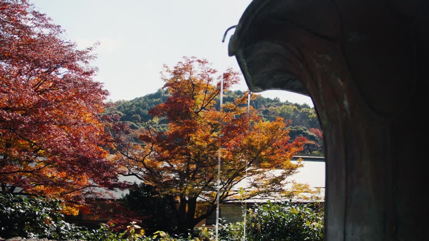 Water dripping from japanese fountain in autumnal garden
