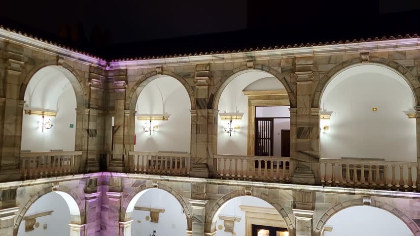 Palace of the Dukes of Feria. Spain. Andalusian courtyard illuminated at dusk with striking lighting of the Parador Nacional de Zafra.